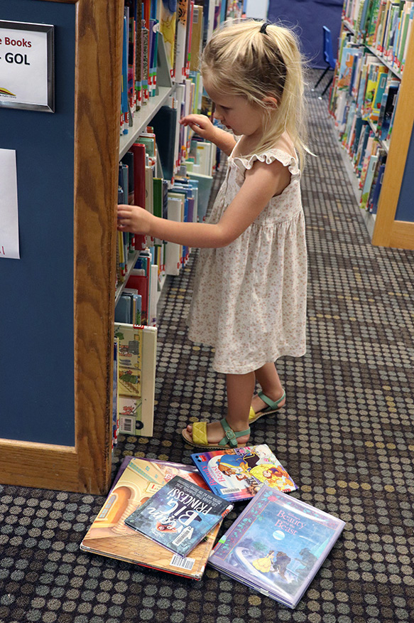 girl picking books
