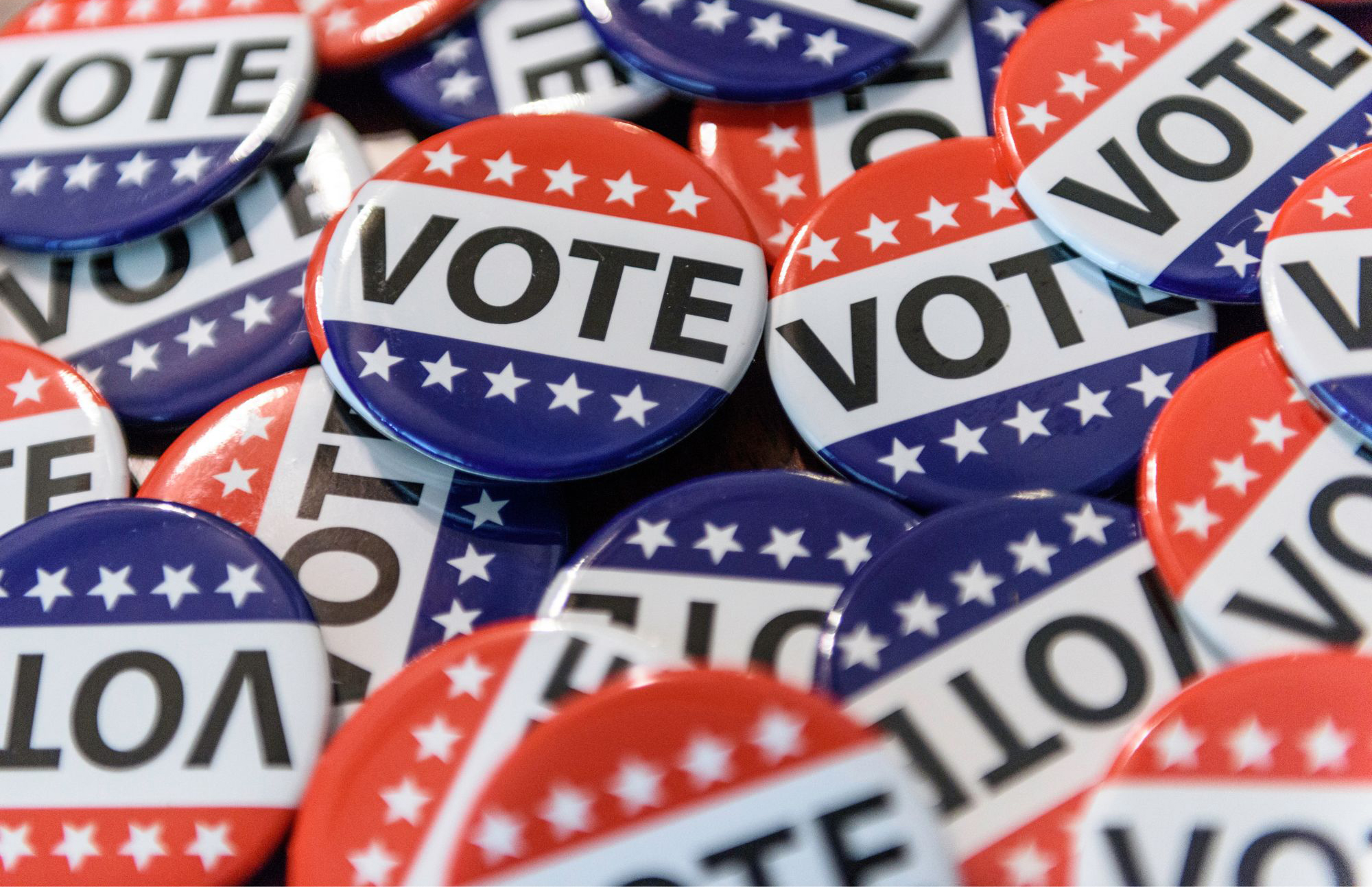 Pile of buttons that read 'vote' with red, white and blue backgrounds